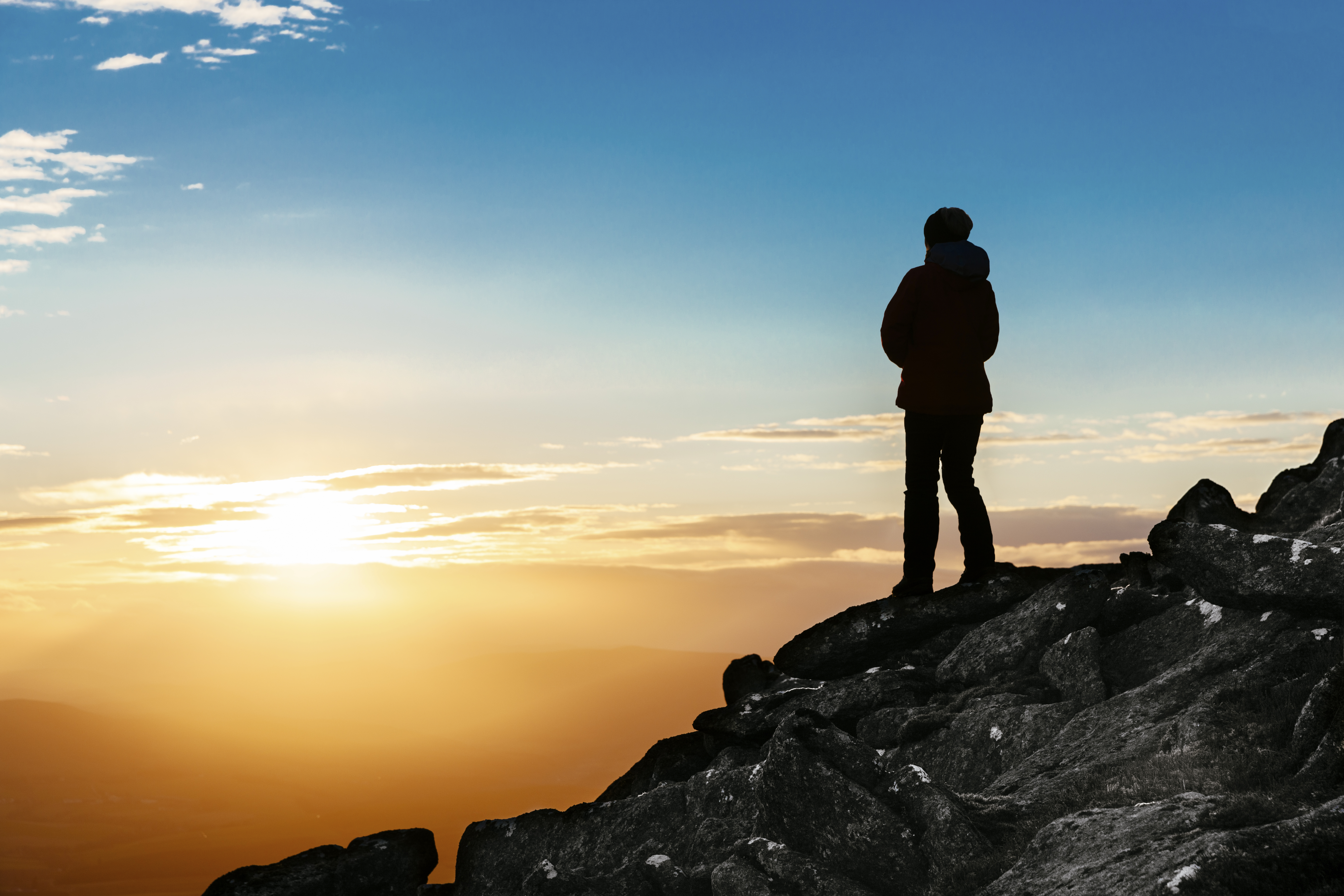 How the Feldenkrais Method changed a young woman's life blog post image of woman standing on a mountain watching the sun set